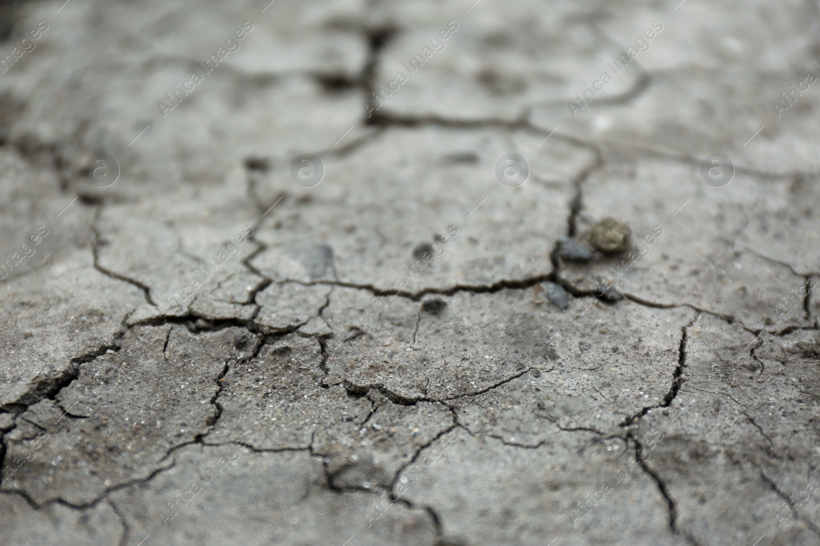 Photo of Dry textured ground surface as background, closeup. Thirsty soil