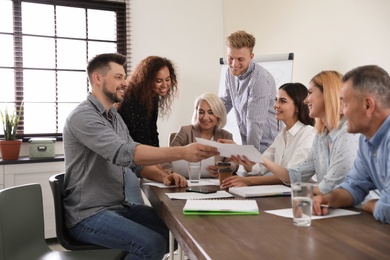 Portrait of volunteers having meeting in office