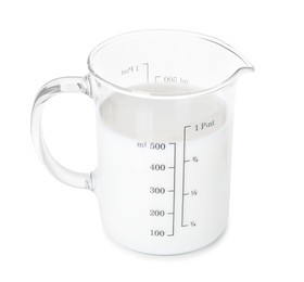 Photo of Fresh milk in measuring cup isolated on white