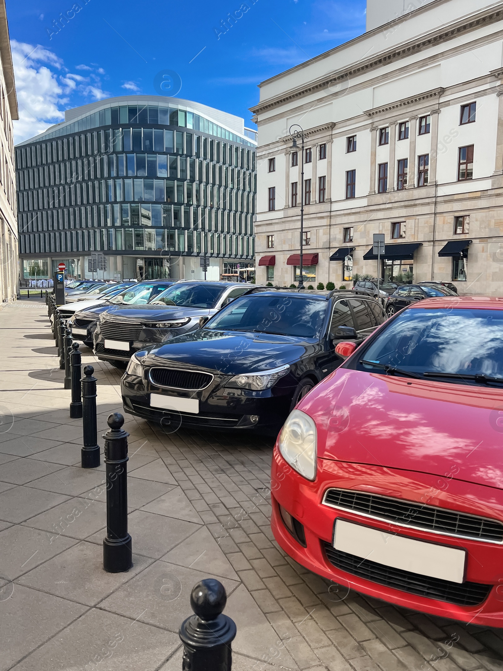 Photo of Different modern cars parked on city street