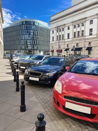 Photo of Different modern cars parked on city street