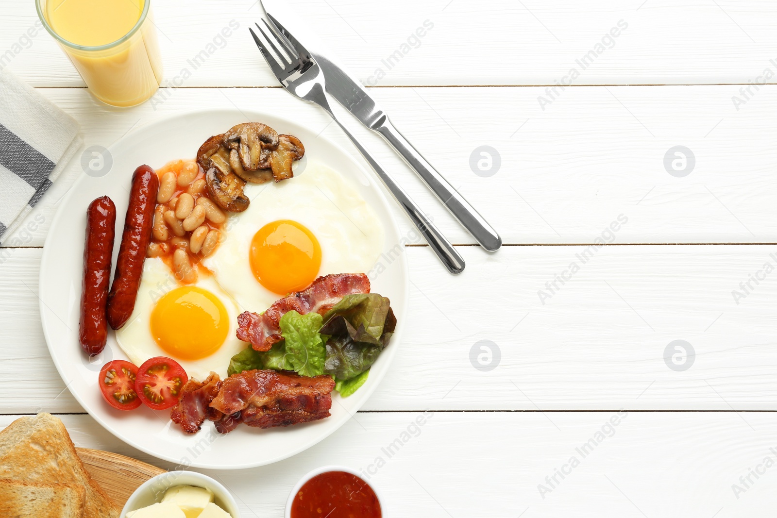 Photo of Delicious breakfast with sunny side up eggs served on white wooden table, flat lay. Space for text