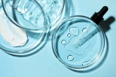 Flat lay composition with Petri dishes on light blue background