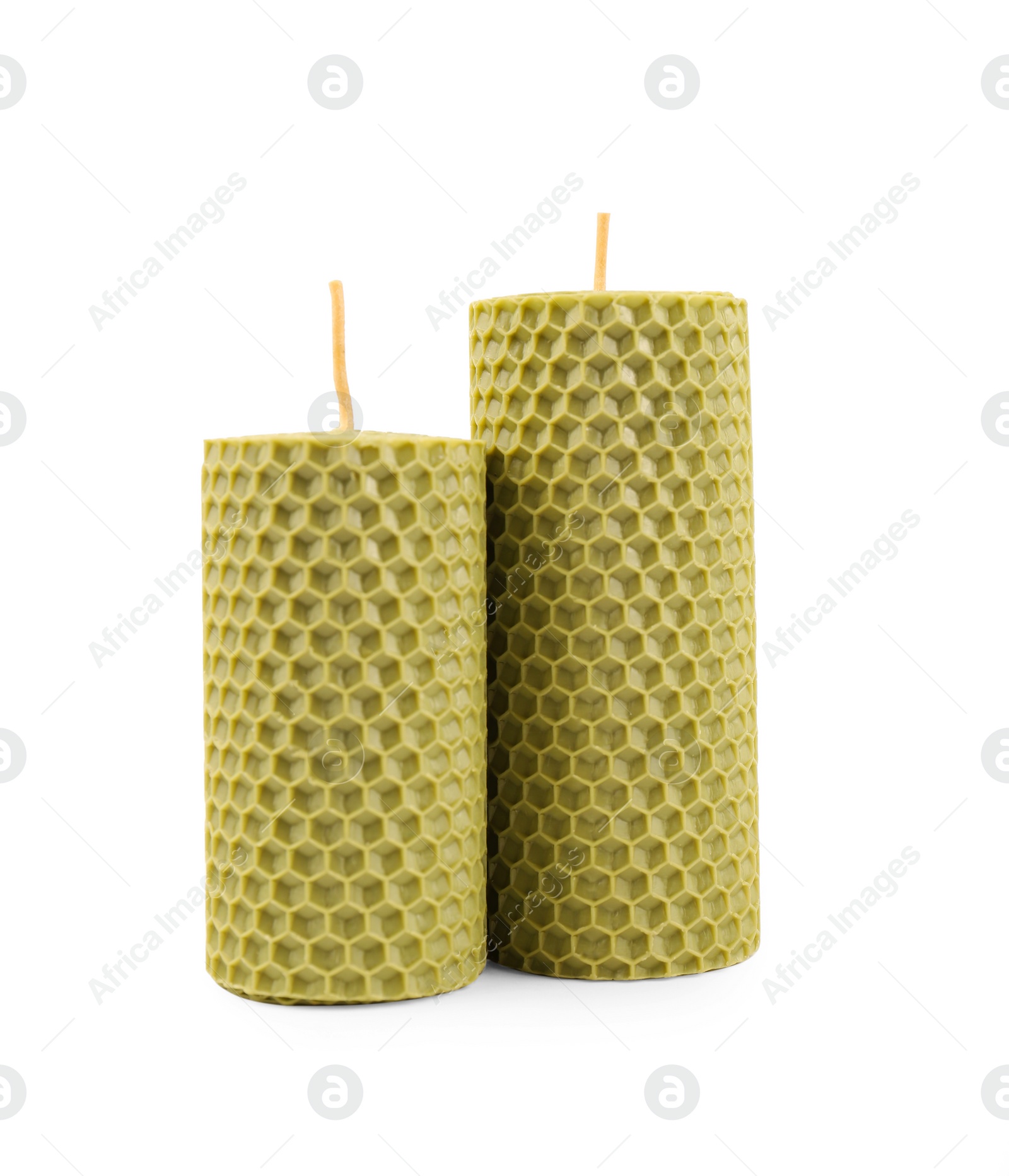 Photo of Stylish elegant beeswax candles isolated on white