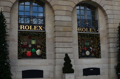 Photo of Paris, France - December 10, 2022: Rolex store exterior with Christmas decor