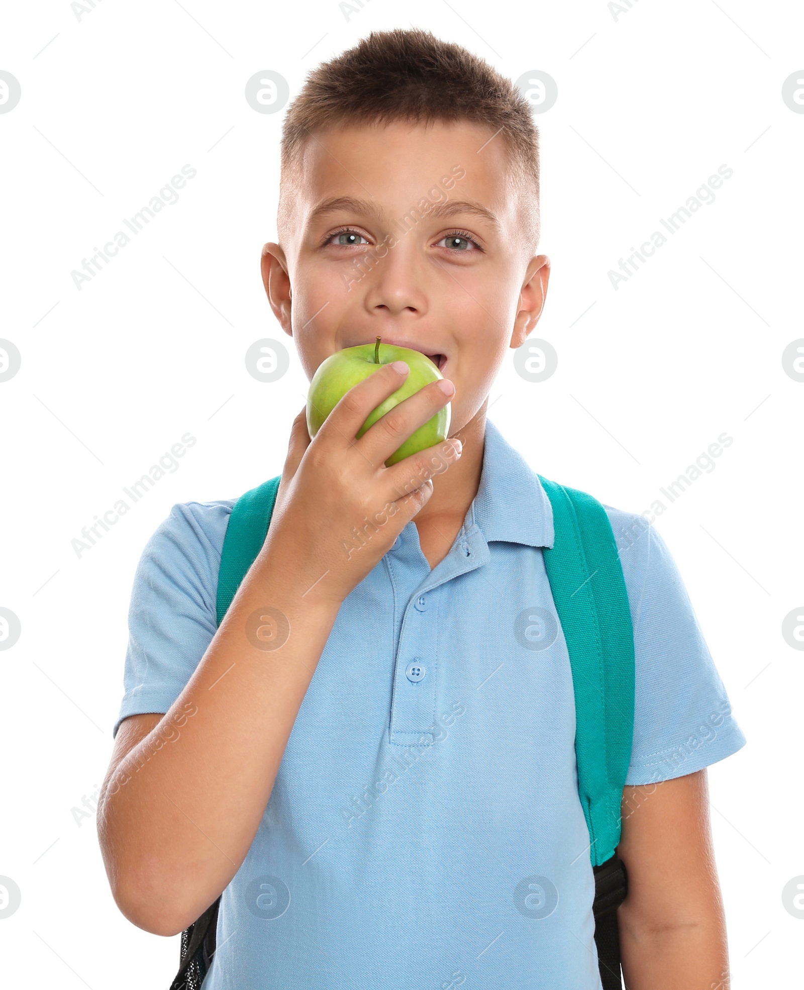 Photo of Little boy eating apple on white background. Healthy food for school