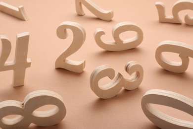 Photo of Many different wooden numbers on beige background