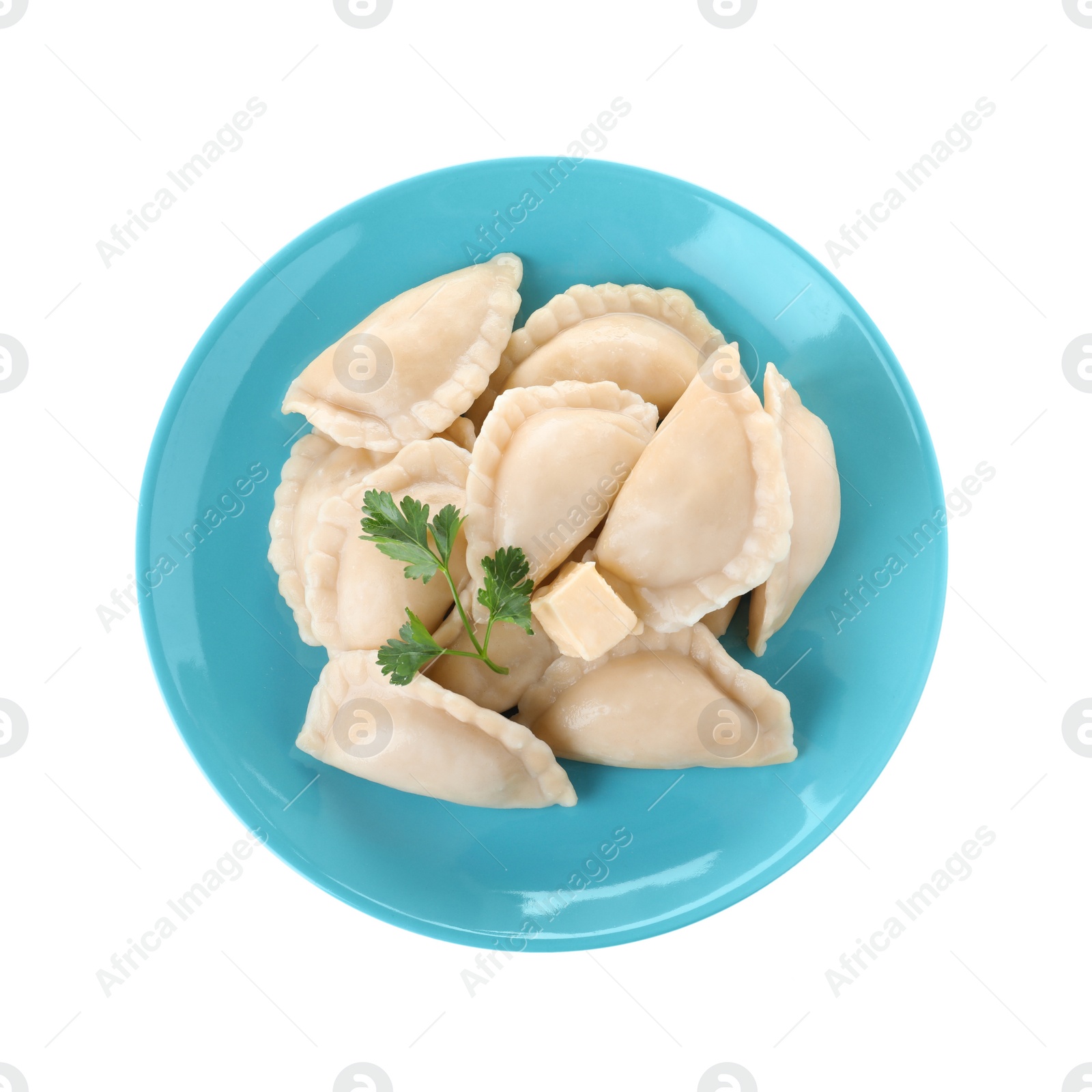 Photo of Plate of tasty dumplings served with parsley and butter on white background, top view