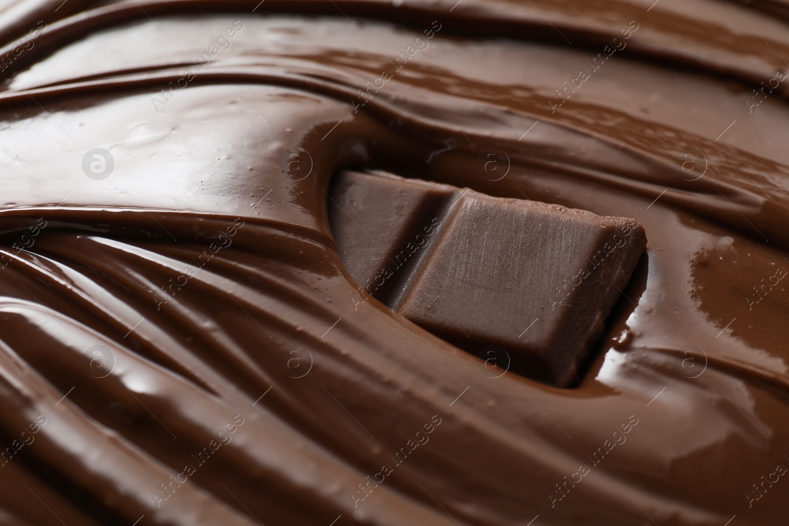 Photo of Tasty milk chocolate paste and pieces as background, closeup