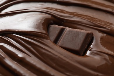 Tasty milk chocolate paste and pieces as background, closeup