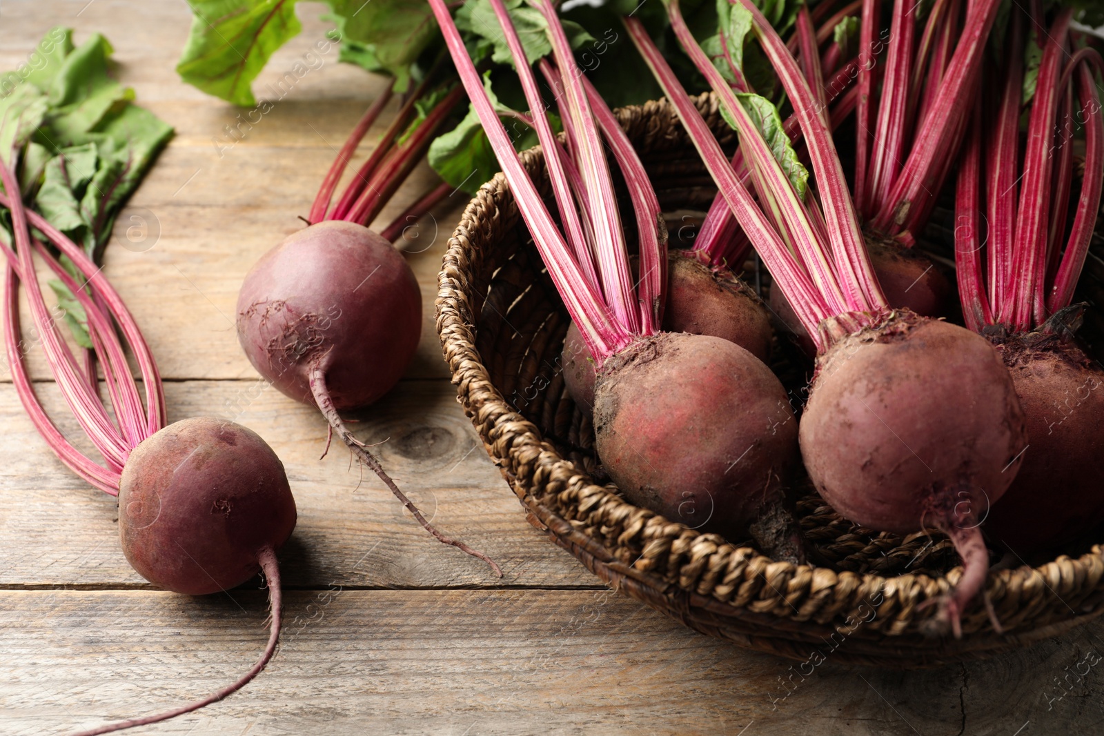 Photo of Many raw ripe beets on wooden table