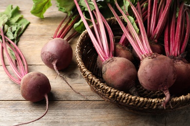 Photo of Many raw ripe beets on wooden table