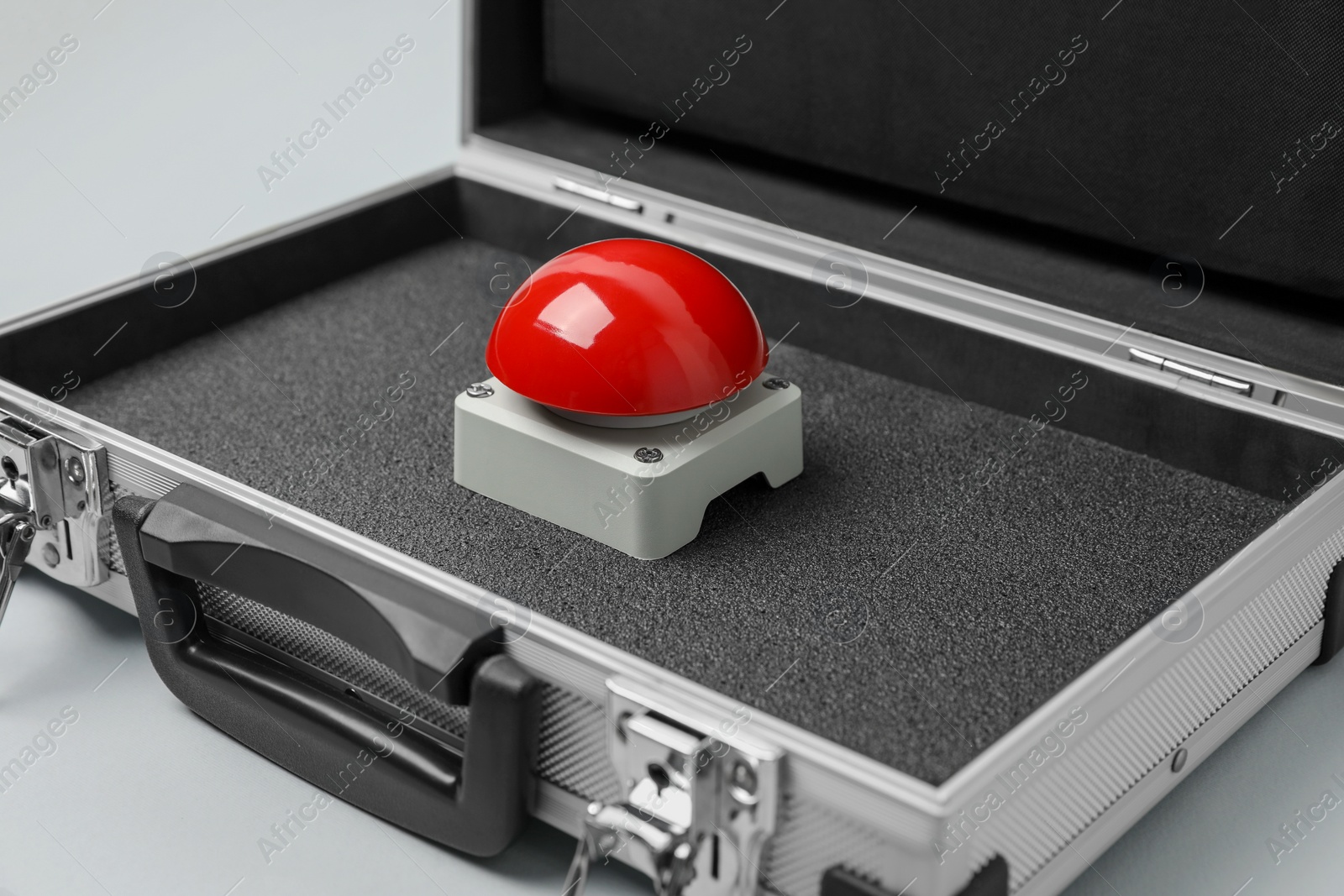 Photo of Red button of nuclear weapon in suitcase on white background. War concept