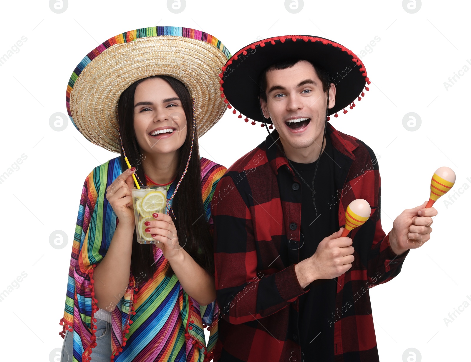 Photo of Lovely couple in Mexican sombrero hats with cocktail and maracas on white background