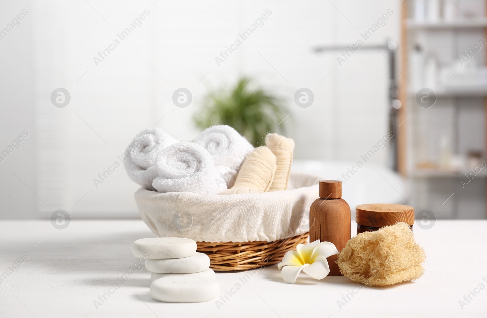 Photo of Composition with spa products on white wooden table in bathroom