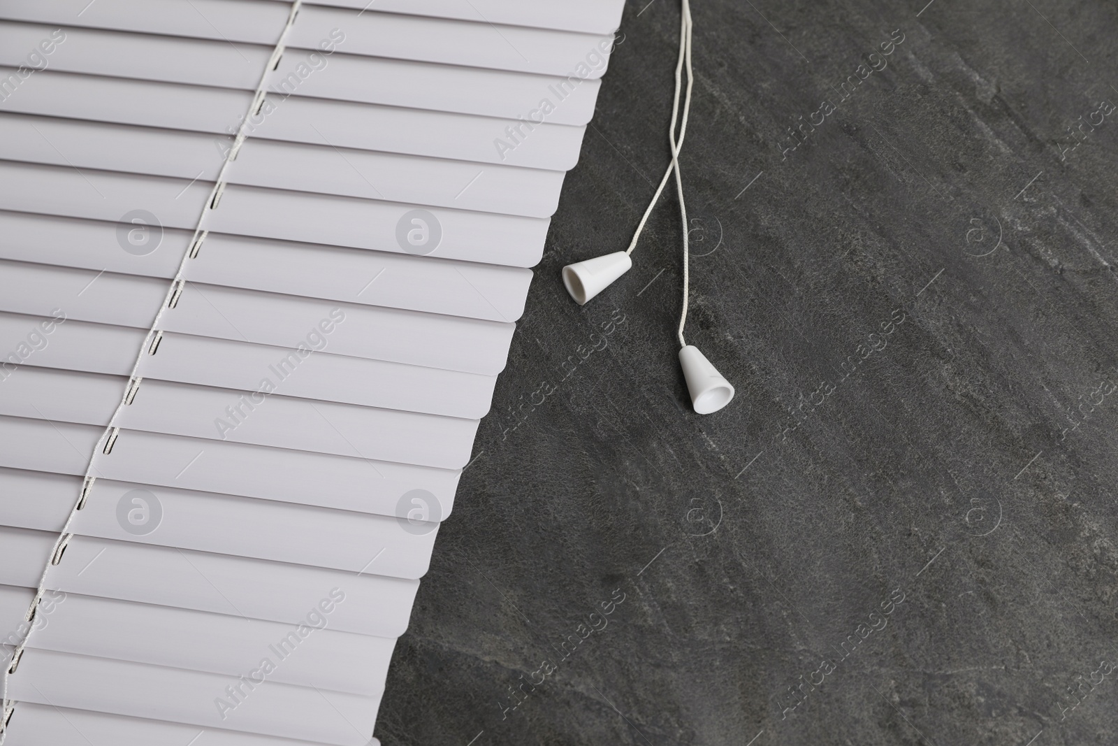 Photo of Stylish horizontal window blinds on black table