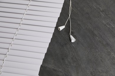 Photo of Stylish horizontal window blinds on black table