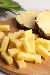 Photo of Pieces of tasty ripe pineapple on table, closeup