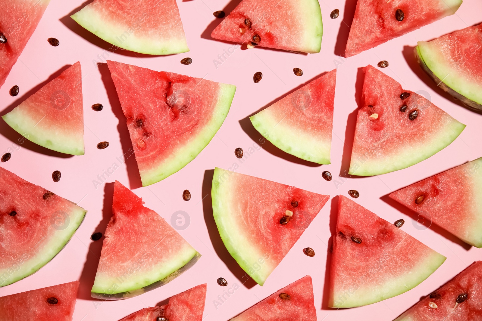 Photo of Watermelon slices on pink background, flat lay