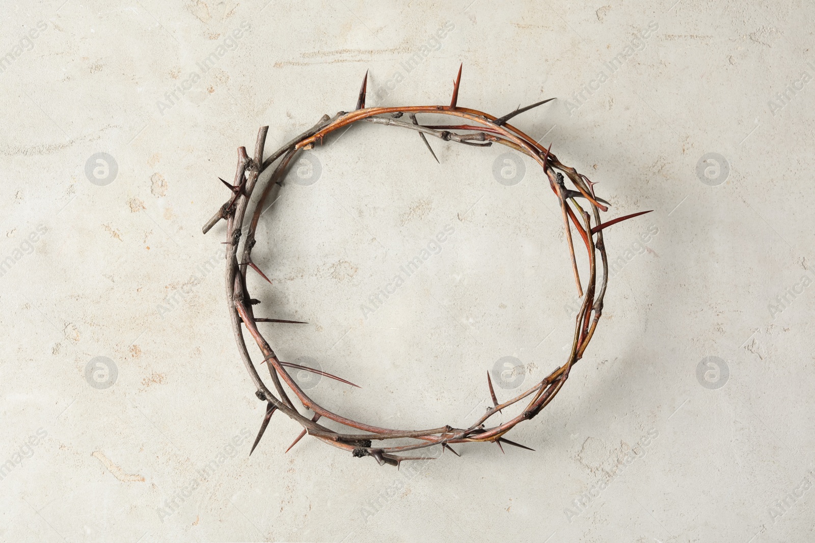 Photo of Crown of thorns on light background, top view. Easter attribute