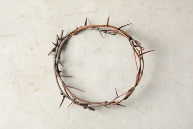 Crown of thorns on light background, top view. Easter attribute