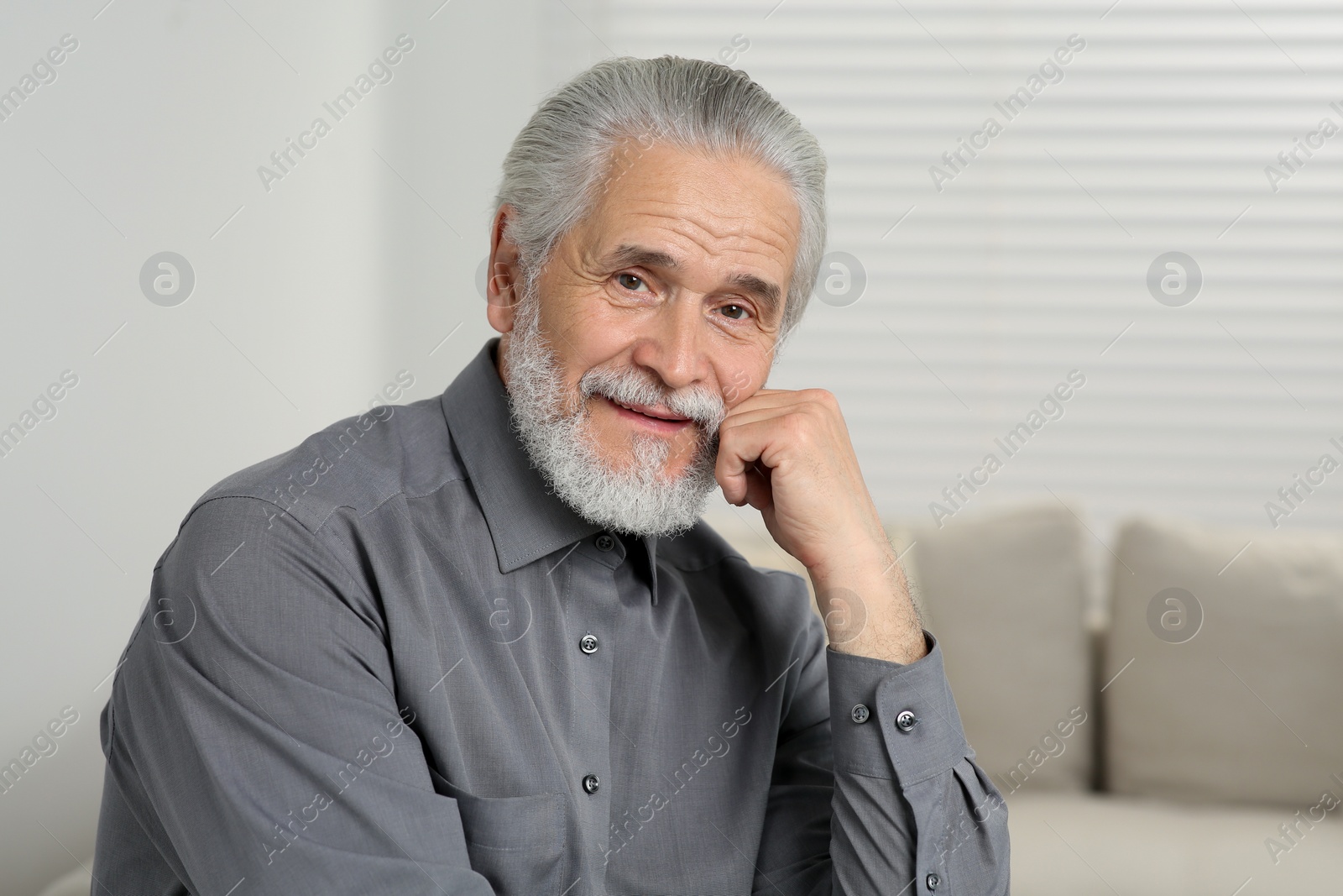 Photo of Portrait of handsome senior man at home