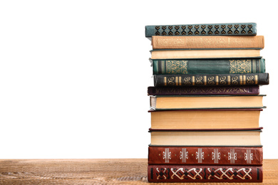 Photo of Stack of old vintage books on wooden table against white background