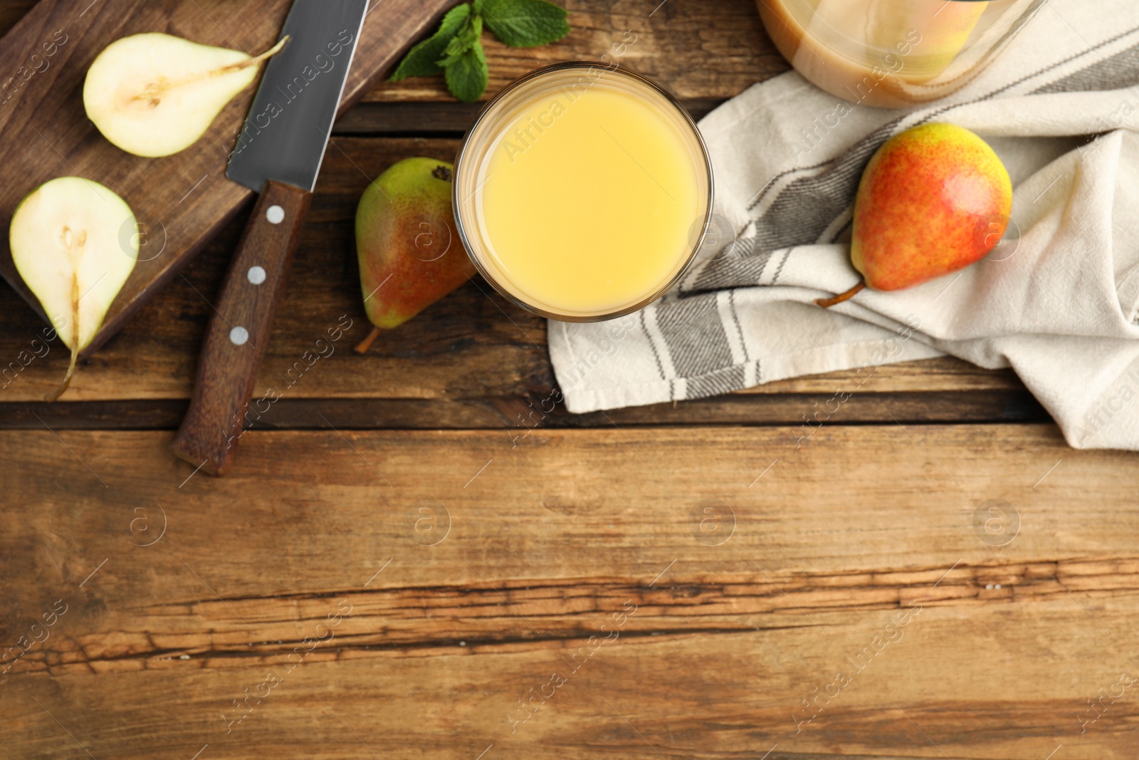 Photo of Tasty pear juice and fruits on wooden table, flat lay. Space for text