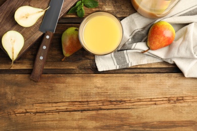 Tasty pear juice and fruits on wooden table, flat lay. Space for text