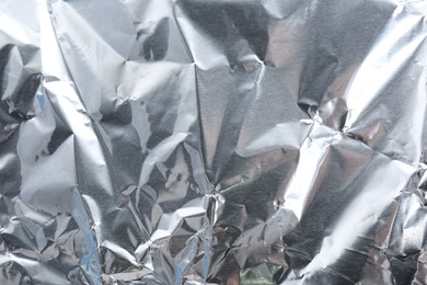 Crumpled silver foil as background, closeup view