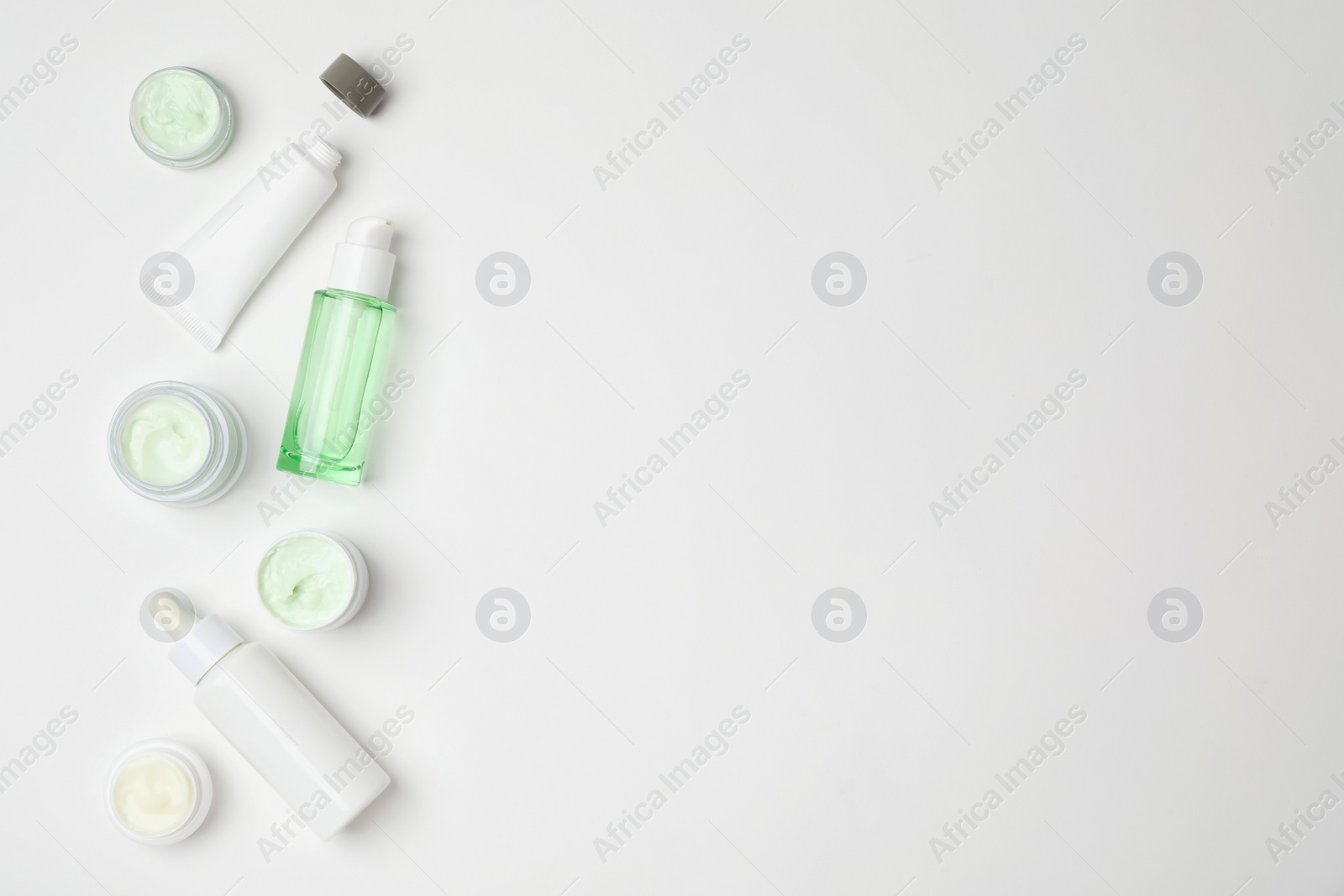 Photo of Flat lay composition with cosmetic products on light background