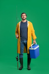 Fisherman with fishing rod and cool box on green background