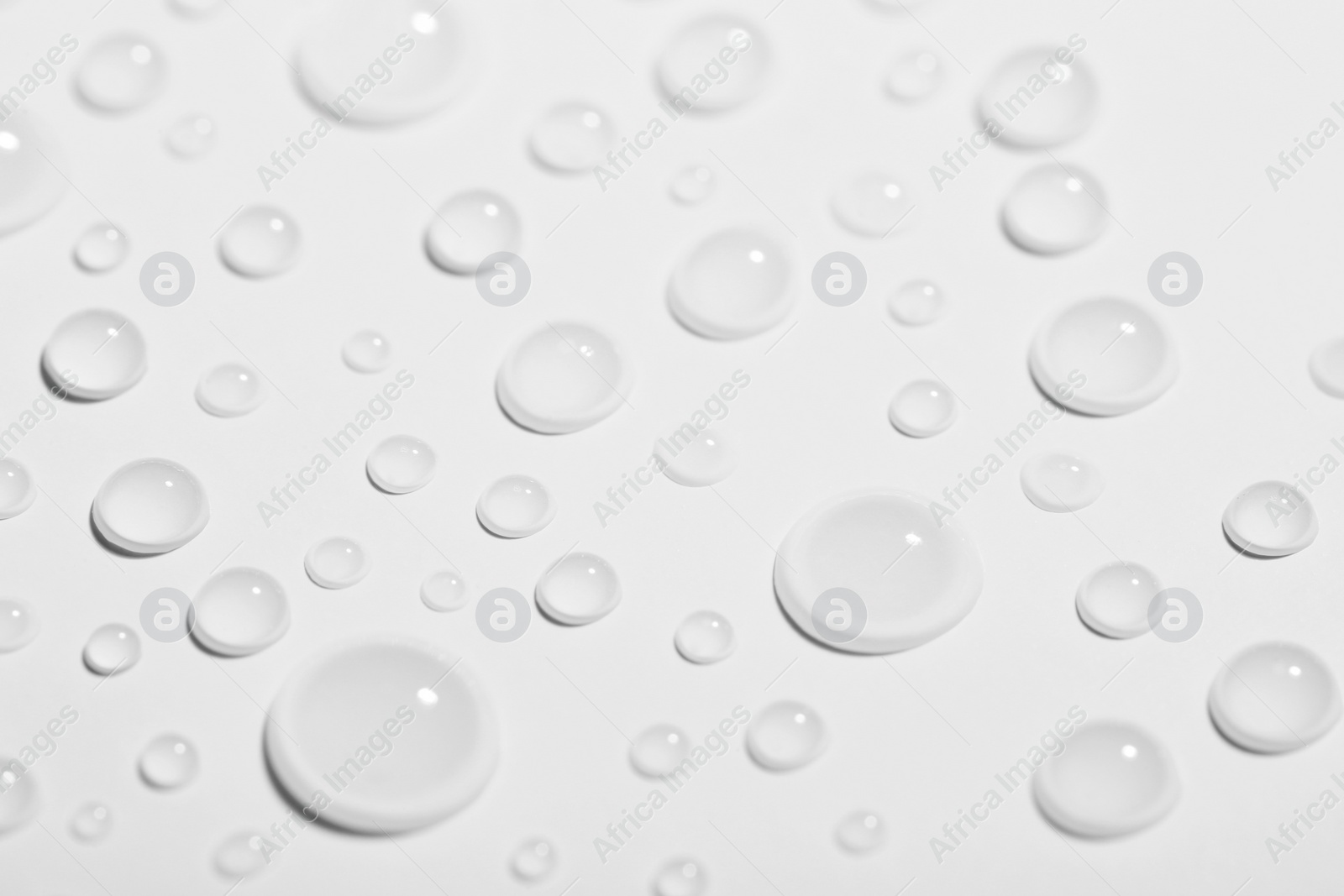 Photo of Pure water drops on white background, closeup