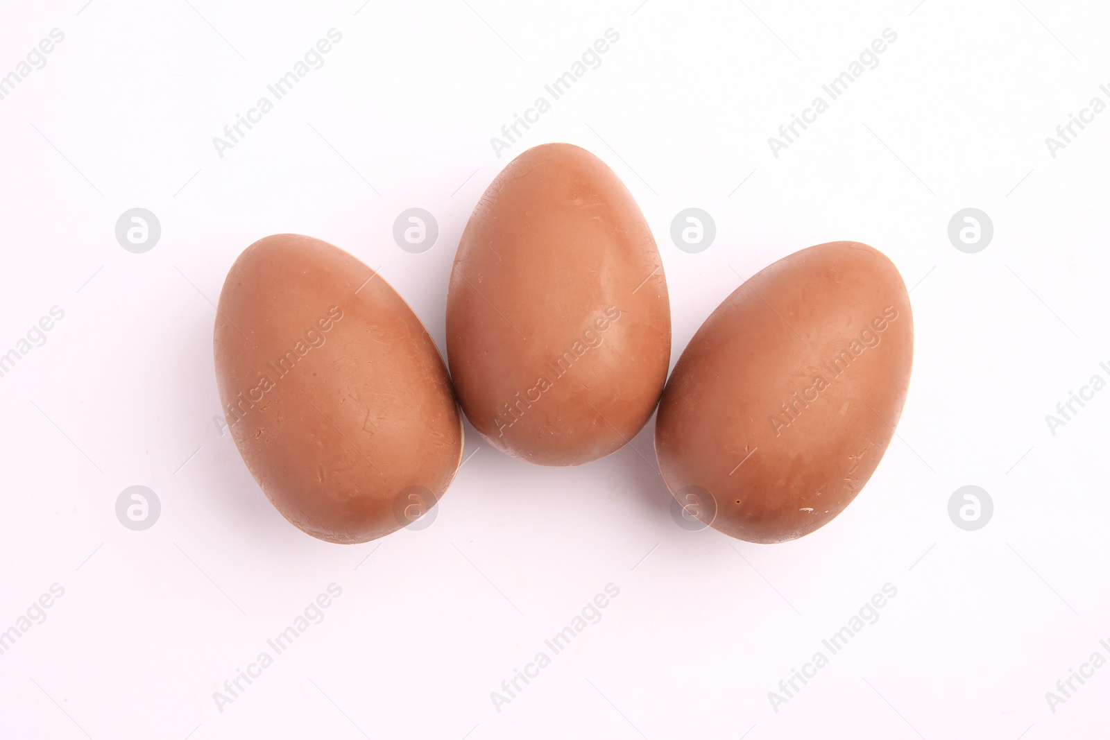 Photo of Sveti Vlas, Bulgaria - June 27, 2023: Unwrapped Kinder Surprise Eggs isolated on white, top view