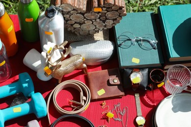 Photo of Many different items on table outdoors, above view. Garage sale