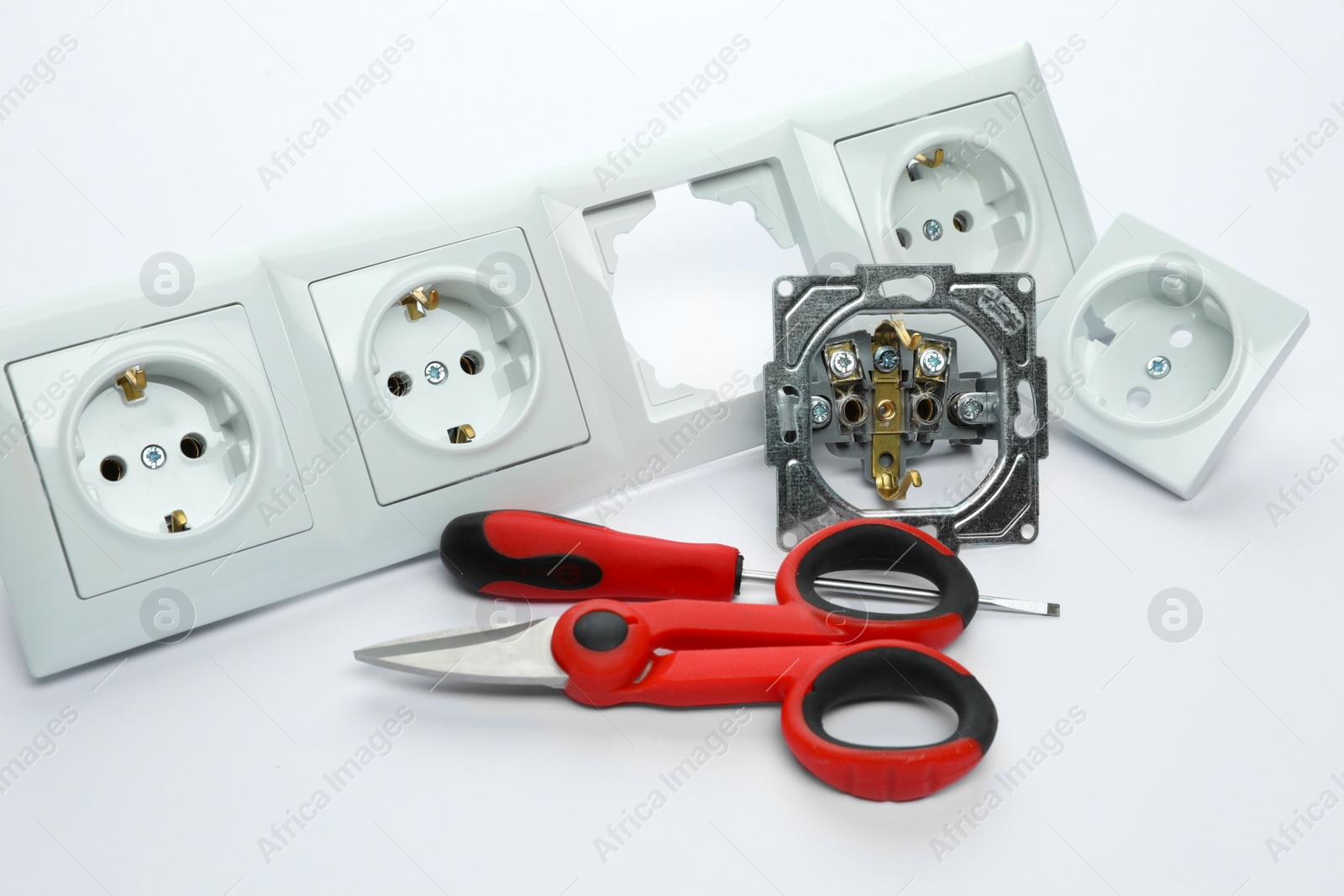 Photo of Set of sockets and electrician's tools on white background