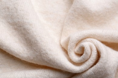 Photo of Soft beige knitted fabric as background, top view