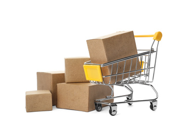 Photo of Shopping cart and boxes isolated on white. Logistics and wholesale concept