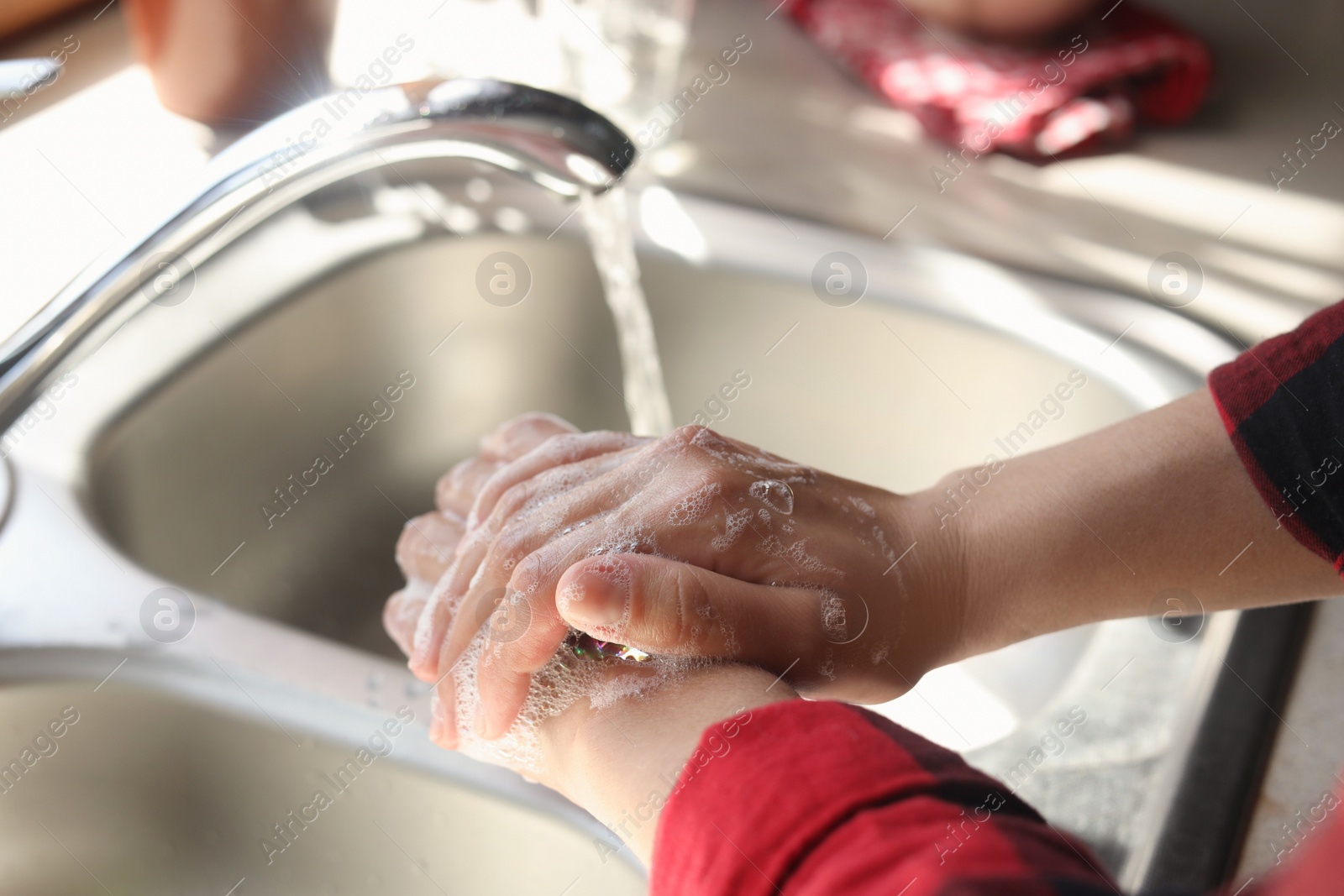 Photo of Woman washing hands in sink, closeup view