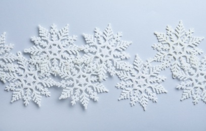 Beautiful snowflakes on white background, flat lay