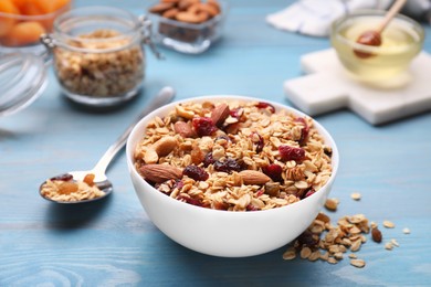 Photo of Tasty granola with nuts and dry fruits on light blue wooden table