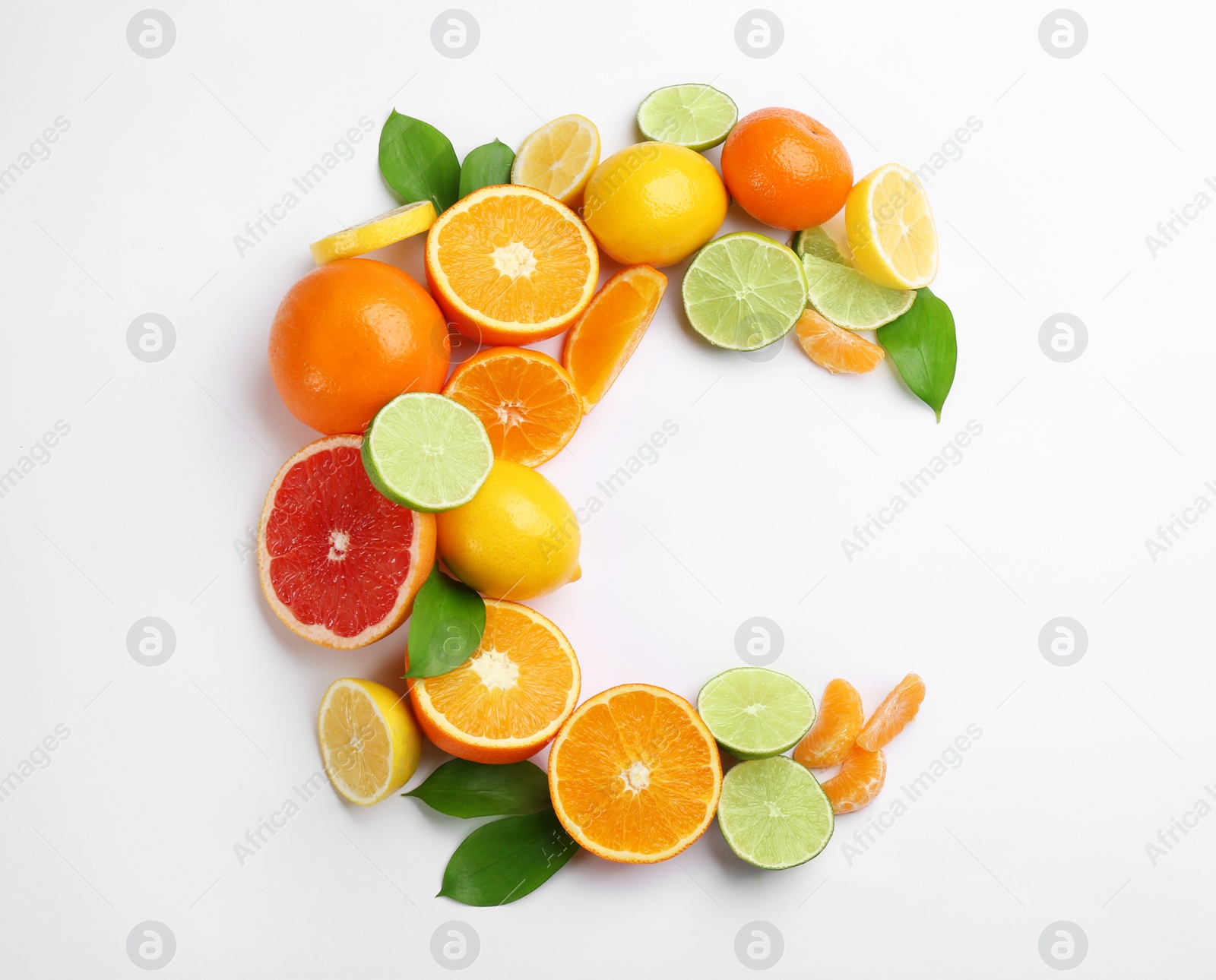 Photo of Letter C made with citrus fruits on white background as vitamin representation, top view