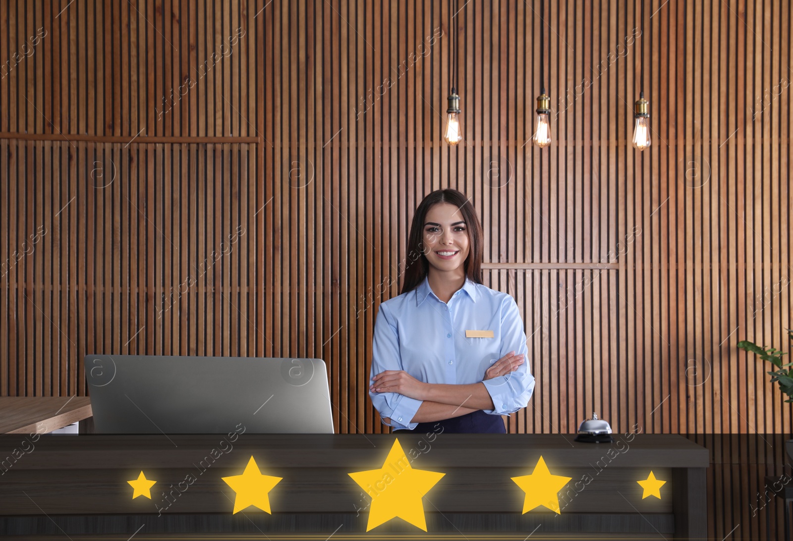 Image of Five Star Luxury Hotel. Portrait of receptionist at desk in lobby