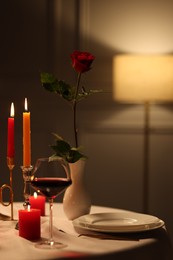 Photo of Elegant table setting with burning candles in restaurant