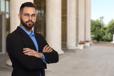 Image of Successful lawyer in glasses near building outdoors, space for text