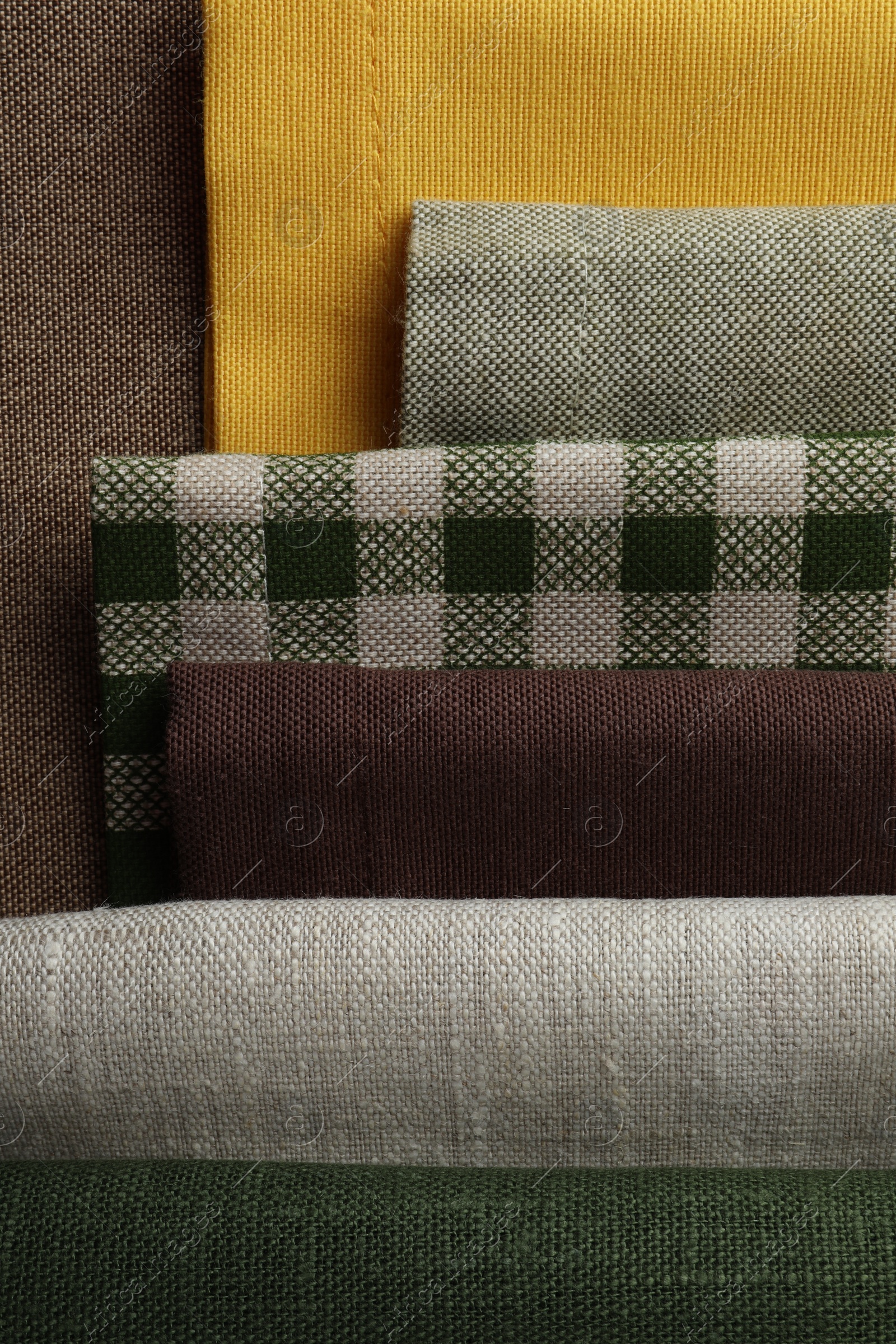 Photo of Many different fabrics on brown cloth, top view