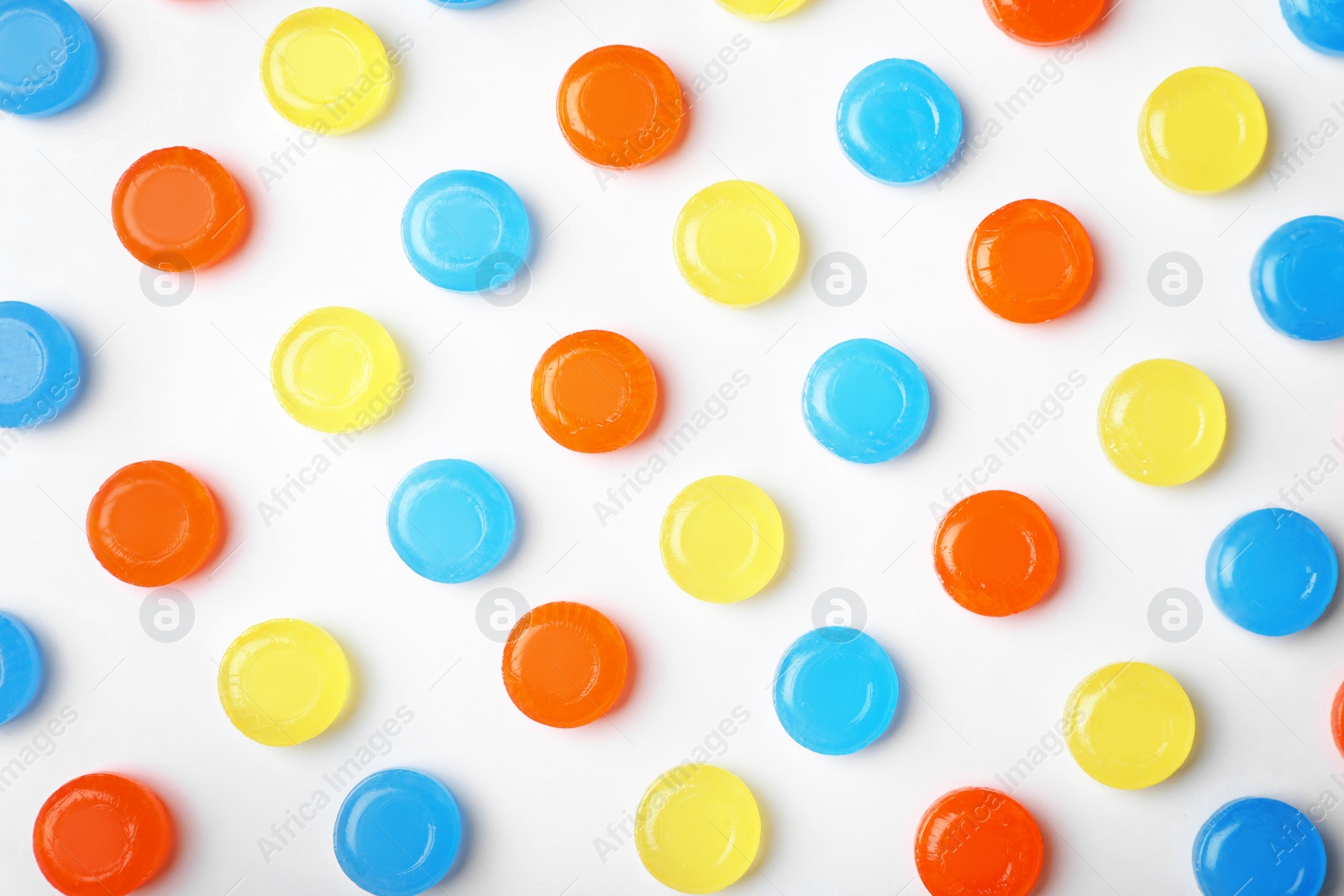 Photo of Composition with color cough drops on white background