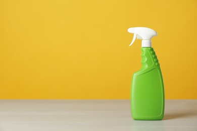 Photo of Bottle of cleaning product on light table. Space for text