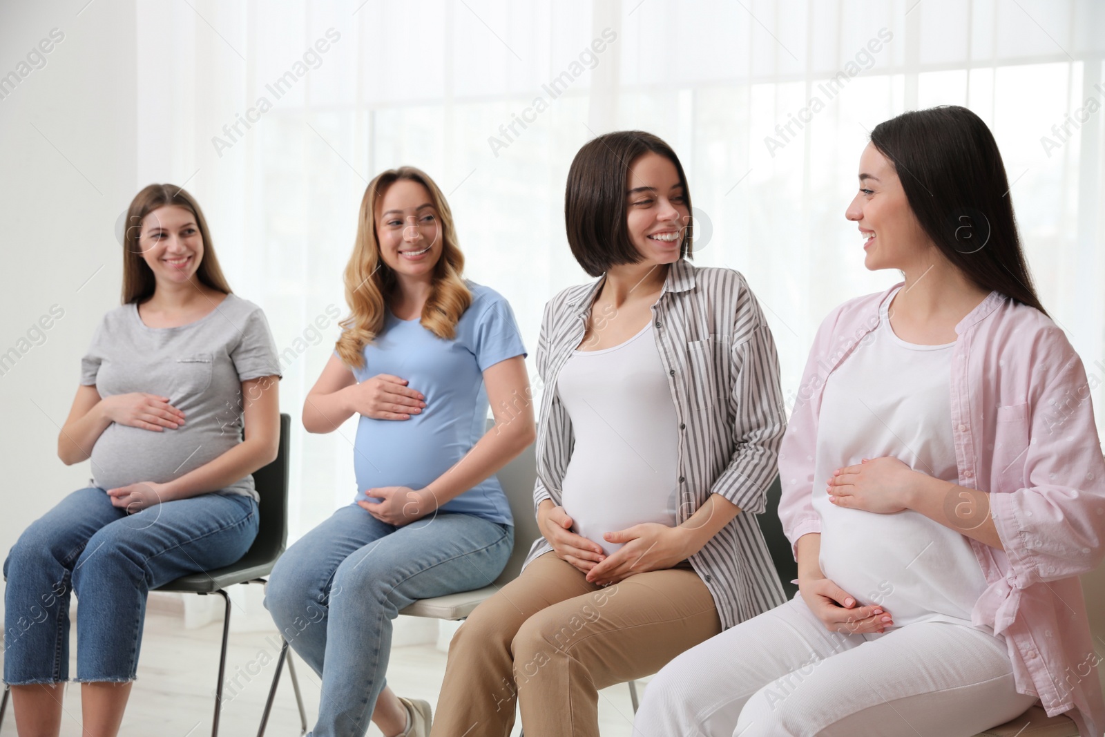 Photo of Group of pregnant women at courses for expectant mothers indoors