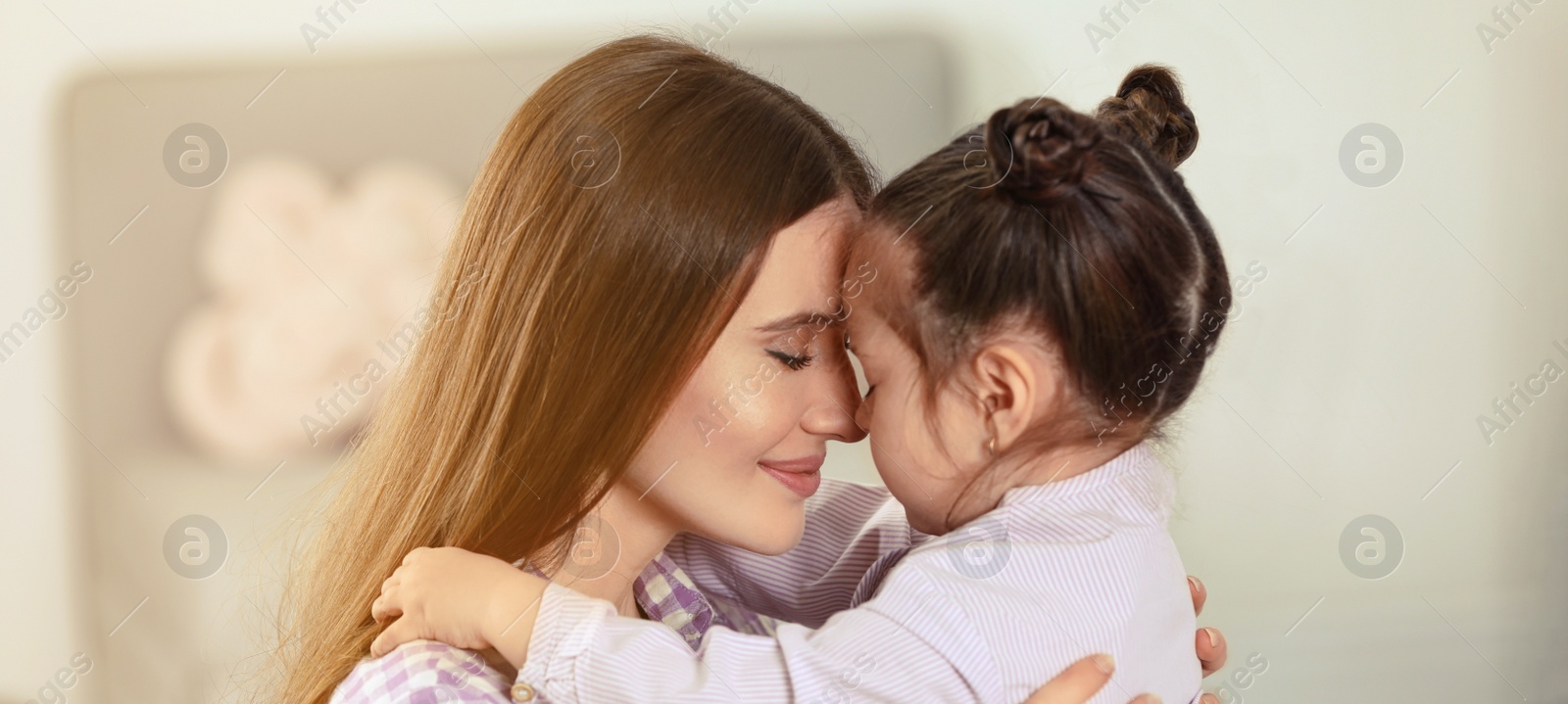 Image of Young mother with little daughter at home. Banner design